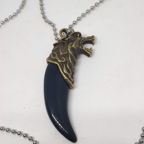 Necklace with wolf tooth pendant like new, gold and black