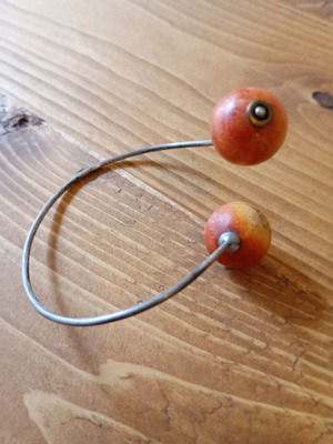 Asymmetric bracelet with orange round beads