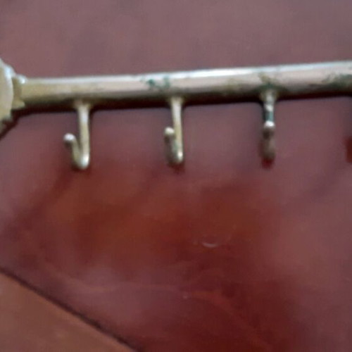Vintage brass key-shaped hanger used, decorative wall hook