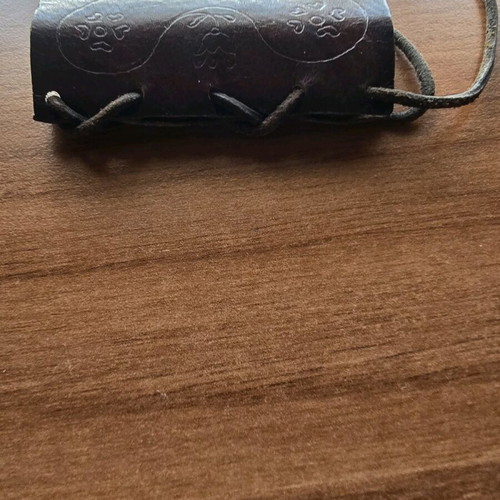 Hanging lighter case like new, carved design