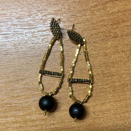 Earrings with beads used, gold and black color