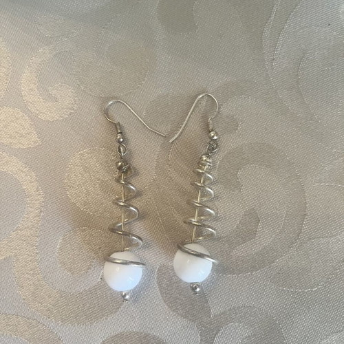 Silver dangling earrings with spiral design and white sphere