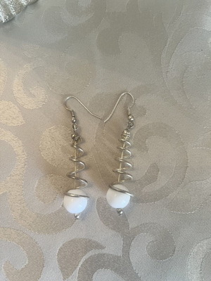 Silver dangling earrings with spiral design and white sphere