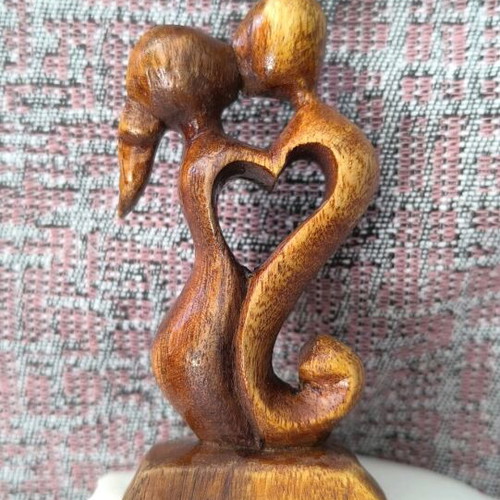 Wooden sculpture embrace like new, natural material decoration