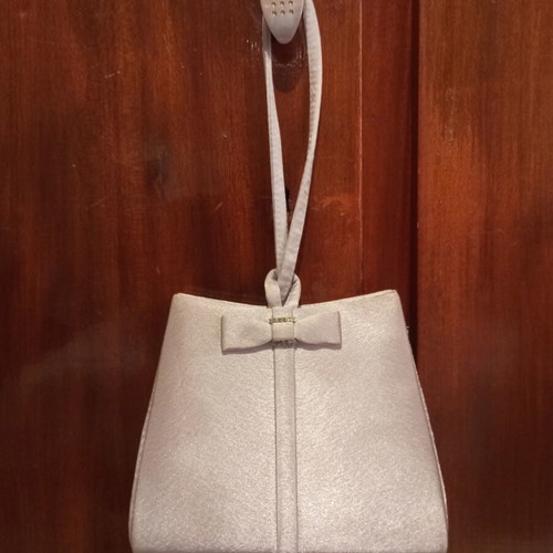 Silver satin evening bag with bow and wrist strap