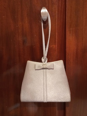 Silver satin evening bag with bow and wrist strap