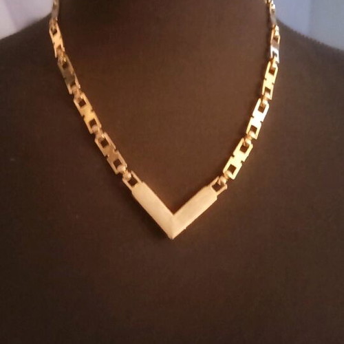Necklace like new, gold color with white and red stones