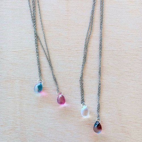 Handmade pendants from iridescent glass and steel