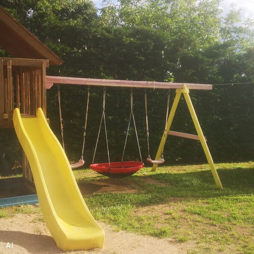 Playground set used with trampoline, seesaw, slide, and swings