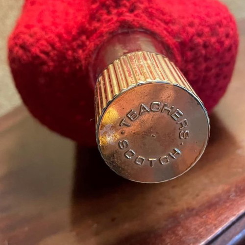 Whisky bottle used with handmade red knitted cover
