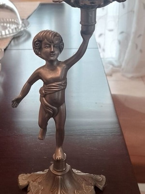 Metal candlestick with child figure decoration like new