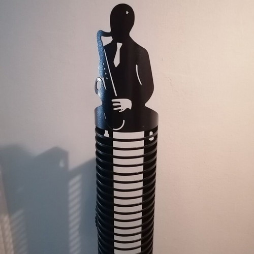 Metal CD holder like new with saxophone player design