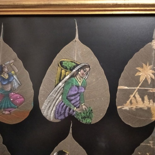 Painting with African figures hand-painted on dried leaves with gold frame and glass