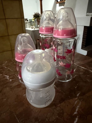 4 baby feeding bottles, 3 glass NUK, 1 plastic Philips