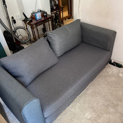 Two-seater grey sofa bed