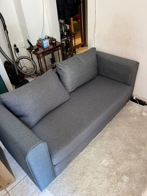 Two-seater grey sofa bed