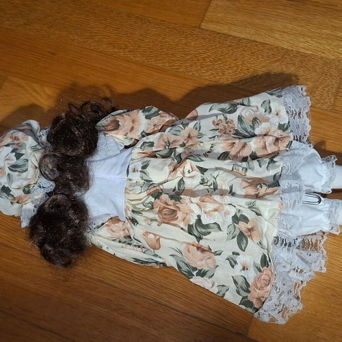Porcelain collectible doll with brown curly hair and vintage dress, new