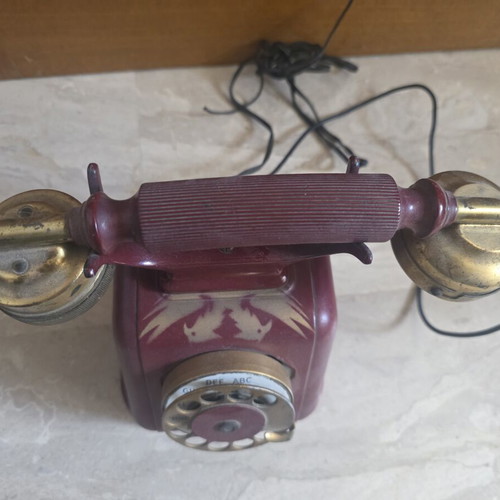 Metal telephone used, red, wired connection