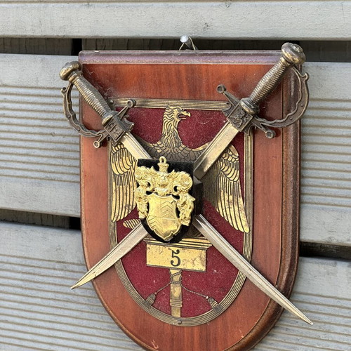 Military crest with crossed swords and eagle on wooden base used