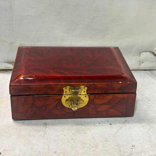Vintage wooden jewelry box used with red satin lining