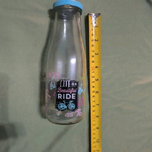 Glass water bottle used with hole for straw