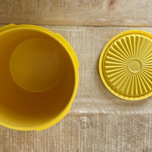 Vintage Tupperware container used yellow with radial lid