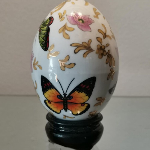 Porcelain egg used with butterflies and wooden base