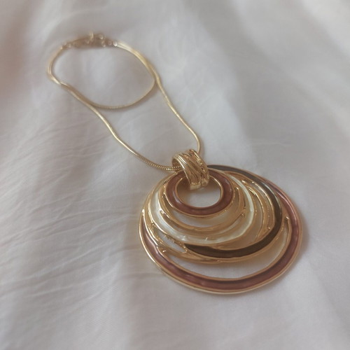 Golden Orbit statement necklace with circular pendant