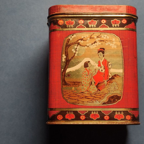 Vintage collectible metal biscuit tin used with Japanese motifs