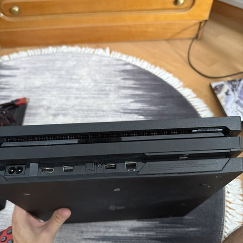 Sony PlayStation 4 Pro 1TB console used with controllers and charging dock
