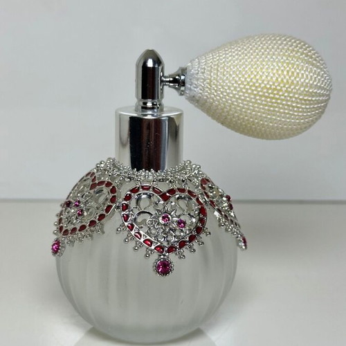 Vintage perfume bottle with pump, decorative hearts and crystals