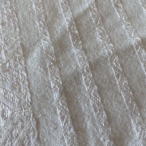 Woven cotton bedspread used with handmade lace trim
