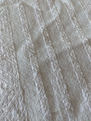 Woven cotton bedspread used with handmade lace trim