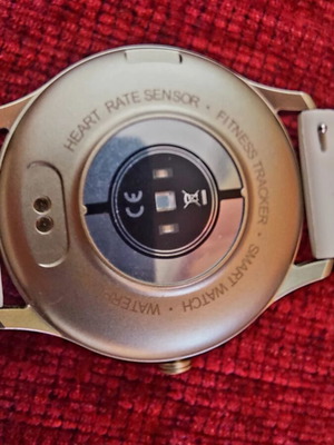 Smart watch, gold with beige strap and black with extra straps