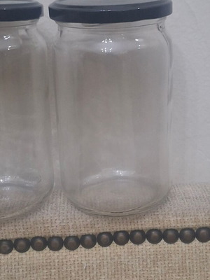 Set of 10 transparent glass storage jars with black metal lids