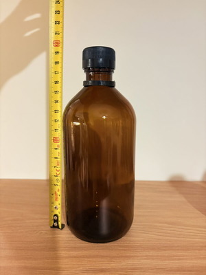 Brown glass pharmacy-style bottle with cap