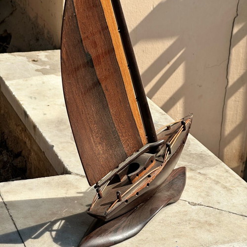 Handmade wooden sailboat used on base, modern nautical decoration