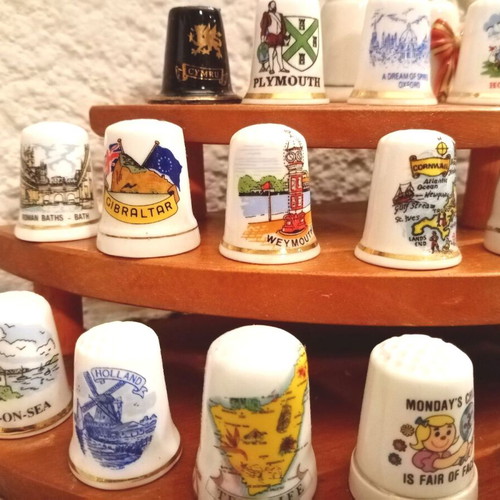 Porcelain thimbles like new, set of 33 with wooden base