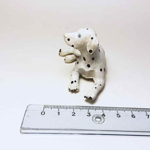 Plastic dog figure used with scratches and marks