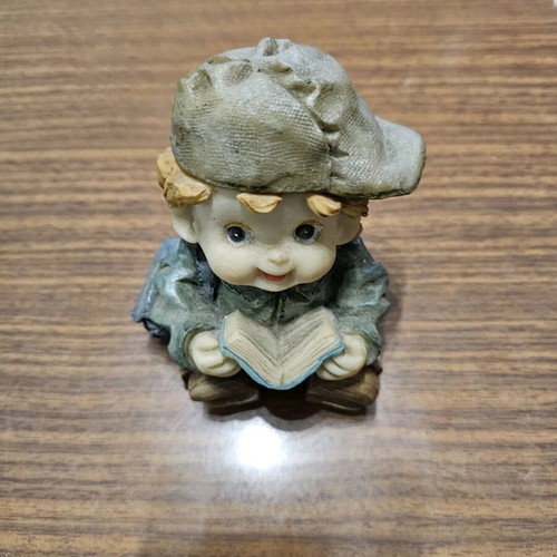 Decorative piggy bank child with book used