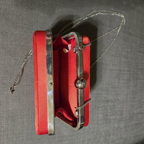 Red satin bag used with silver details and chain strap
