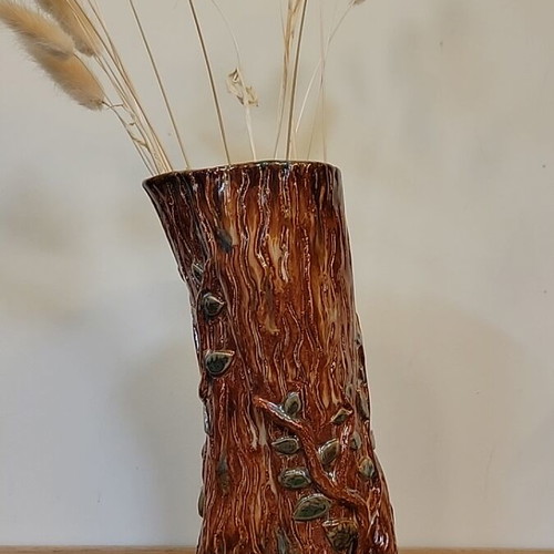 Handmade ceramic vase with natural decorative elements