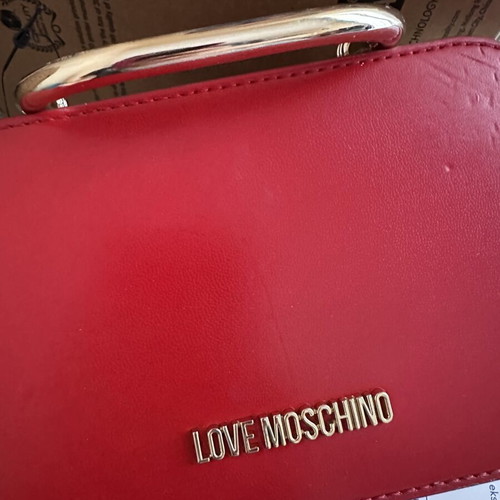Love Moschino red shoulder bag like new with gold metal clasp and embossed detail