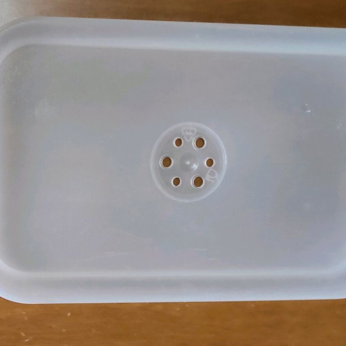Kitchen utensils used, strainer in tupperware with lids