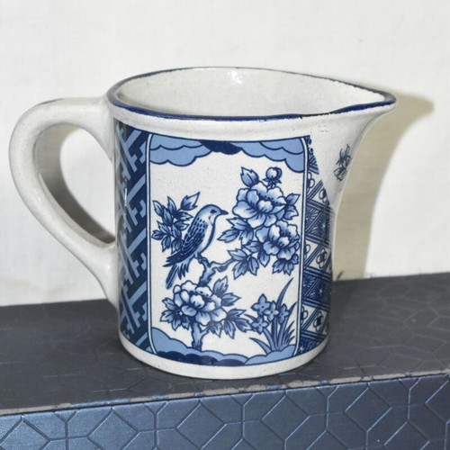 Vintage ceramic jug blue and white with bird and floral motifs used