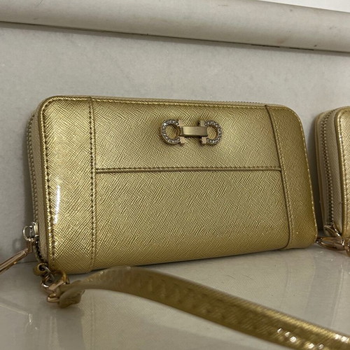 Two gold wallets, one with wrist strap