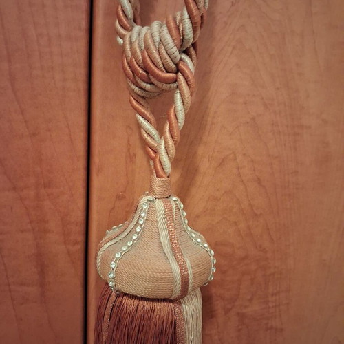 Curtain tieback used, gold-orange color