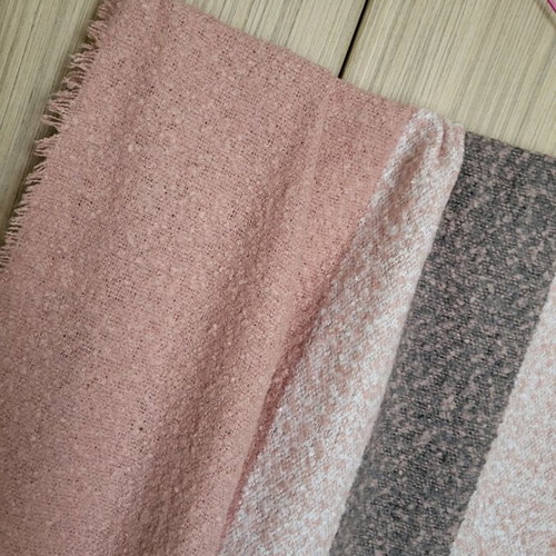 Winter scarf used in pink and gray shades with fringes