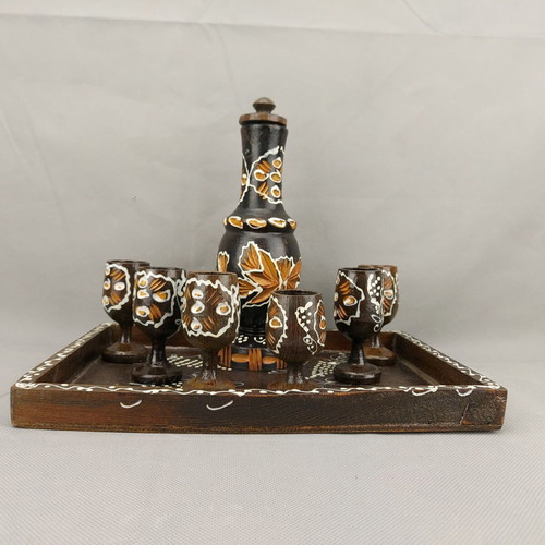 Vintage carved painted wooden bottle with 6 glasses on wooden tray used