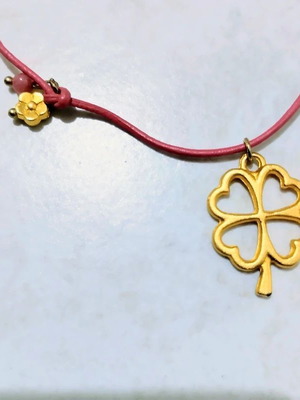 Four-leaf clover charm necklace with coral leather